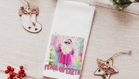 hippie Santa throw pillows for couch, peace on earth kitchen towels for Christmas, hot pink Santa Claus holiday hosting decor home decor