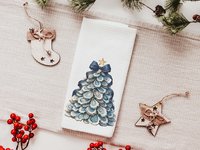 CapableByDesign oyster shell Christmas tree with navy bow pillows and matching towels